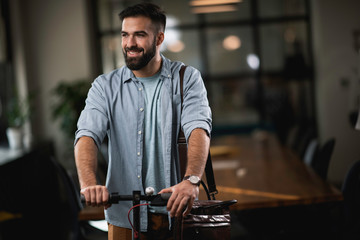 Young man on e-scooter. Businessman driving electric scooter in office. 