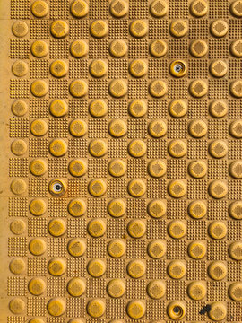 Yellow blind crosswalk pattern sidewalk