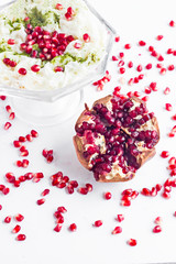 Traditional Turkish Ramadan Milky Dessert;Gullac in glass bowl with pomegranate seeds.Vertical image