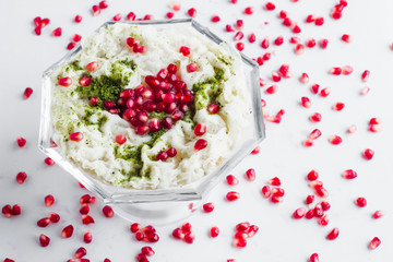 Traditional Turkish Ramadan Milky Dessert;Gullac in glass bowl with pomegranate seeds.Above view.