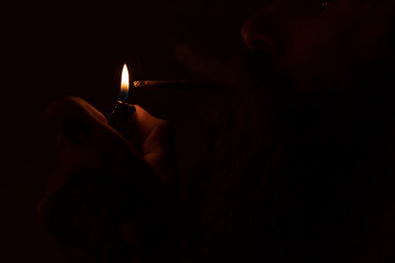 Lighting a marijuana joint, smoke