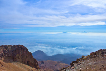 Climbing the Iztaccihuatl volcano, Popocatepetl volcano in Mexico, Tourist on the peak of high rocks. Sport and active life concept