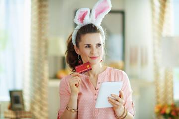 female using tablet PC at modern home in sunny spring day