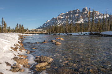 Fototapeta premium Winter view of the steel truss bridge over the Bow River at Castle Junction in Banff National Park, Alberta, Canada