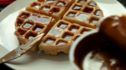 Sunday morning waffles with Syrup, butter and caramel.