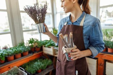 Young female herbalist gazing at a bouquet