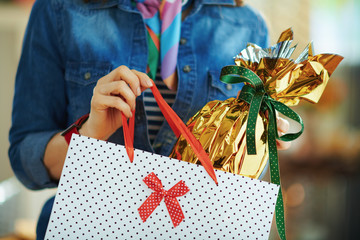 40 years old woman taking out easter egg from shopping bag