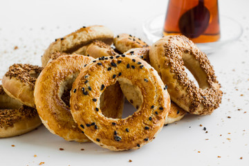 Traditional Turkish Kandil Sesame Rings  which is eaten on Kandils.Kandil is one of the five Islamic holy nights :Mevlid,Regaip,Mirac,Berat,Kadir. Sesame rings with tea on white.