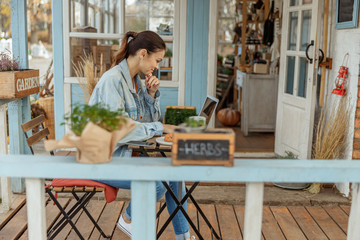 Girl in a denim jacket at a laptop