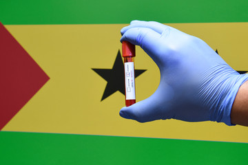 Corona virus or Covid-19 in sao tome , sample blood tube in hand with sao tome flag on background