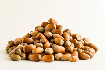 Ripe,new crop hazelnuts heap on white background with copy space