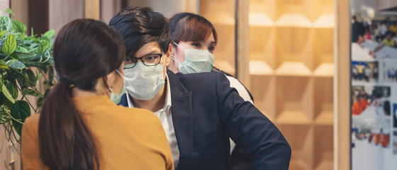 business people wearing medical mask for coronavirus covid 19 protection working together at coworking spaces, working safety in novel coronavirus covid 19 outbreak situation, selective focused
