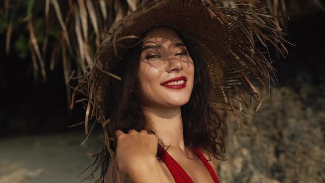 Young mixed race woman with a scar on torso and in a hat at hot summer day. Smilinng portrait. Beauty, travel, fashion and body positive concept.