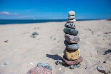 Fototapeta na wymiar A stone figure at a sunny beach at the Baltic Sea.