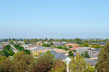 Obraz premium Aerial view of residential houses in Melbourne's suburb. Elevated view of Australian homes against blue sky. Copy space for text. Point Cook, VIC Australia.