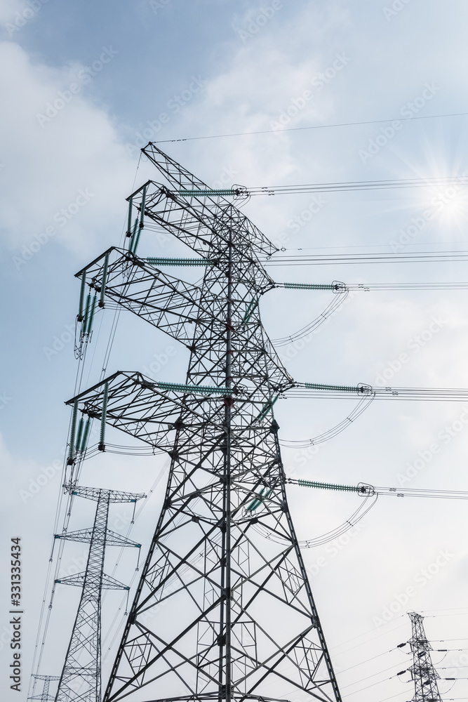 Wall mural transmission tower in sunlight