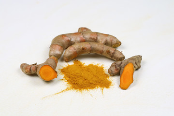 Turmeric powder and turmeric root extracts on a white background are used as skin care ingredients and food products. Turmeric helps the skin to be strong.