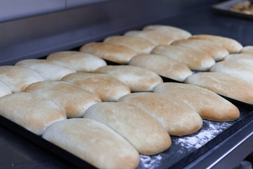 baked bread in trays ready to be sold