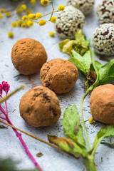 Sweet vegan protein cocoa chocolate oatmeal with dates, carob, coconut meat, sesame seeds and banana energy balls or bars. Healthy dessert.