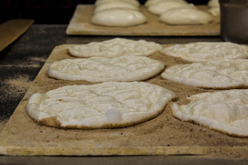 Traditional Turkish Ramadan bread (pide)preparing in the bakehouse.Close up taken