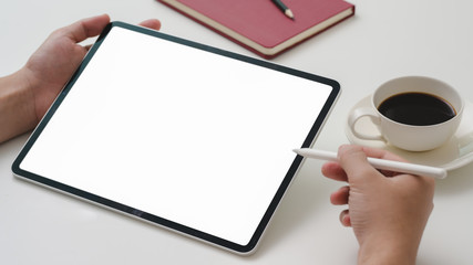 Cropped shot of male entrepreneur working on mock-up tablet with stylus pen