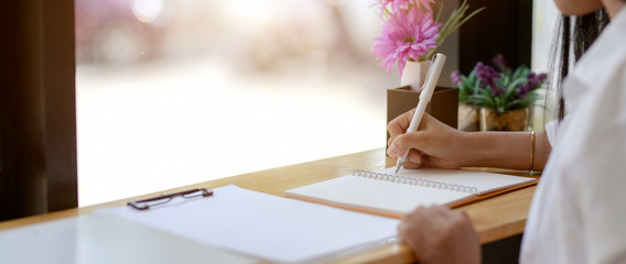 Close up view of female university student preparing for her exam in cafe