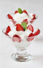 cheese cream. whipped curd cream with strawberries. Homemade cottage cheese is whipped with cream.  A useful dessert. On a light background.