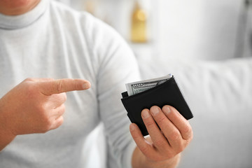 Senior man with purse at home, closeup