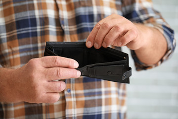 Senior man with empty purse, closeup