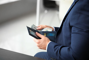 Businessman counting money in office