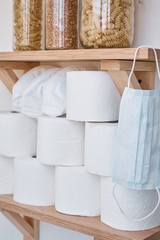 Consumer buying panic about coronavirus covid-19 concept. Toilet paper roll, pasta, and buckwheat on shelf at home. People are stocking up essentials for a home quarantine