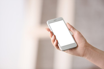 Young woman with mobile phone at home