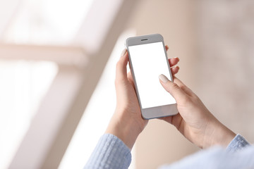 Young woman with mobile phone at home