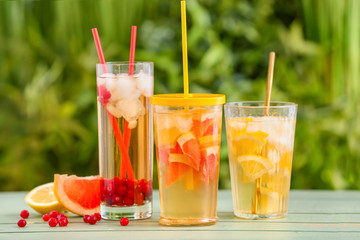 Glasses with cold tea on table outdoors