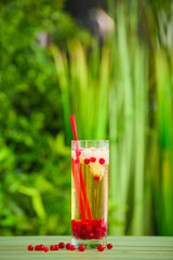 Glass with cold tea on table outdoors