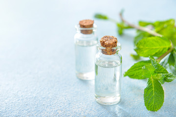 Bottles of mint essential oil on table