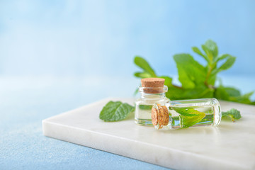 Bottles of mint essential oil on table