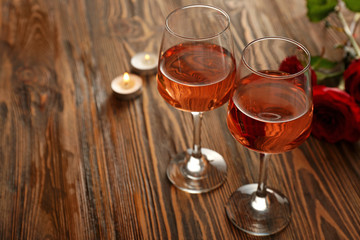 Glasses of wine on wooden table