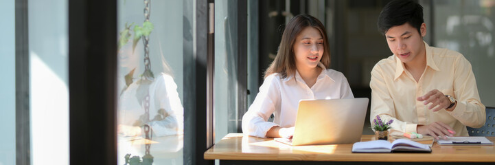 Cropped shot of University students working on their assignment together