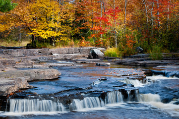 Chilly water flows over stair-steps in the shale riverbed of the Sturgeon River in Michigan's Upper Peninsula.