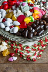 Traditional Turkish Hard Candies designed in vintage metal tray on wooden table.Conceptual image of celebrations.