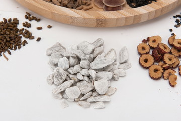 A group of herbs on a white background, large Chinese herbs in a wooden bowl, close-up of medicinal plants and aromatic plants