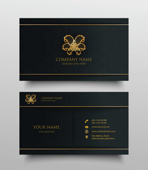 Naklejka premium business card with gold floral logo and place for text on dark background