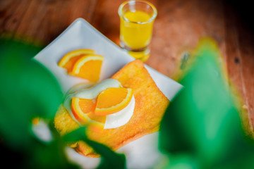 Toast with Yogurt , yuzu orange and  honey  in  white plate on  wooden table, Breakfast baked