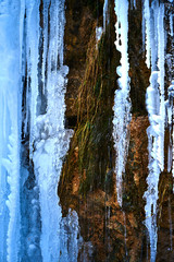 Icicles on the rock. Frozen waterfall in winter.
