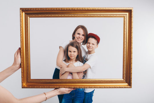 the concept of a healthy lifestyle , child protection, shopping - teenagers and woman together. Happy children: family on a white background. Live picture - the girls and boy look out of the frame