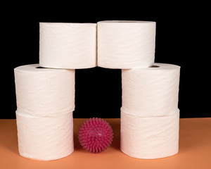 Representation of microscopic view of COVID-19 virus cell under stack of toilet paper on the side. Black background with space for text
