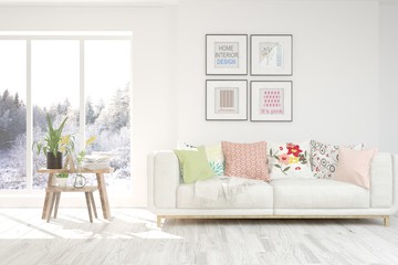 Modern living room in white color with sofa and winter landscape in window. Scandinavian interior design. 3D illustration