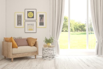 Mock up of stylish living room in white color with armchair and green landscape in window. Scandinavian interior design. 3D illustration