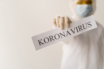 Woman's hand holding a black letter board with the text phrase Coronavirus. New coronavirus...